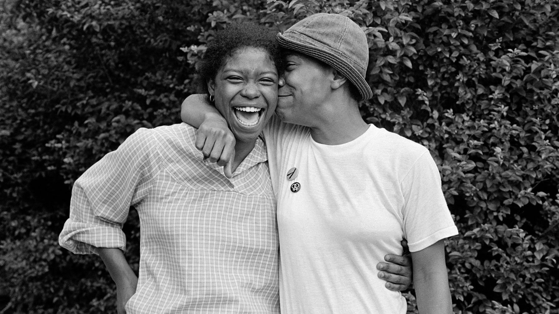 Black and white image of two women embracing and smiling