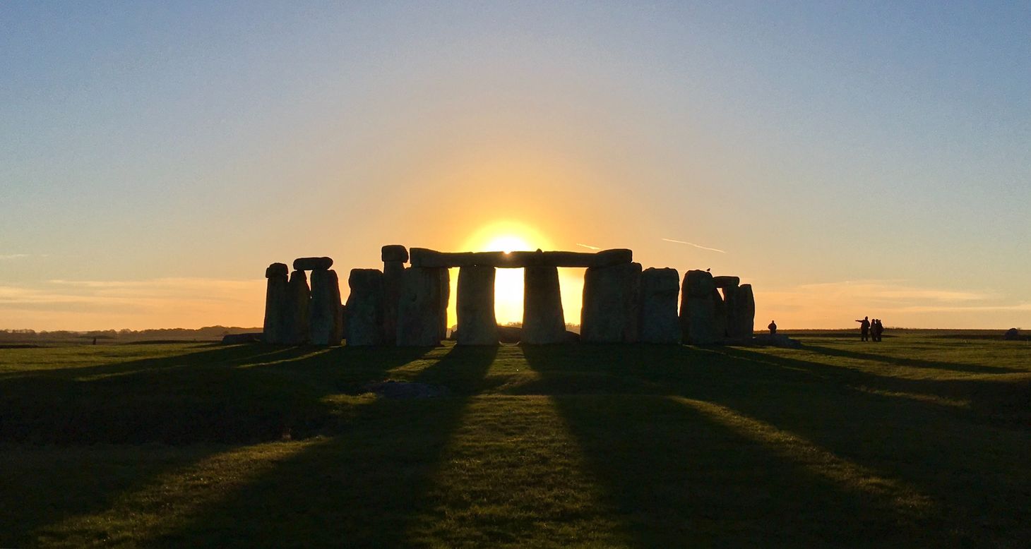 Stonehenge photographed with the rising sun behind